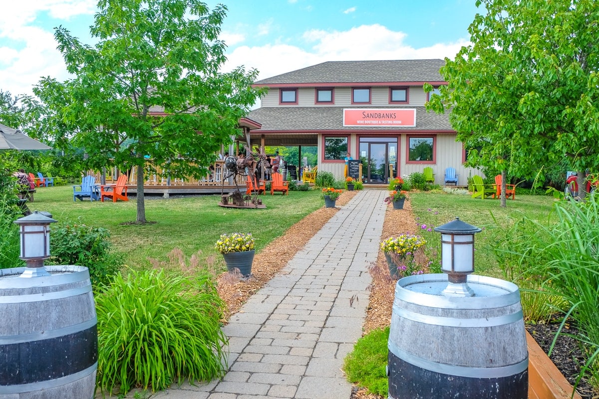 sidewalk with lights leading to entrance of building at sandbanks winery